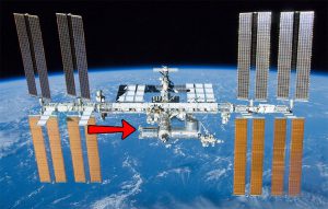 A view of the International Space Station with a red arrow pointing at the Columbus External Payload Facility