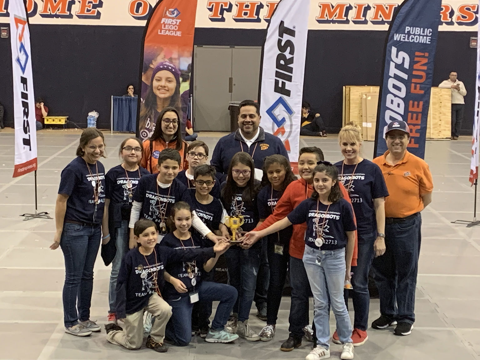 The Dragonbots team hold up their trophy. Representatives from UTEP are also present in the background.