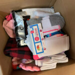 A box of gloves, shirts, and socks